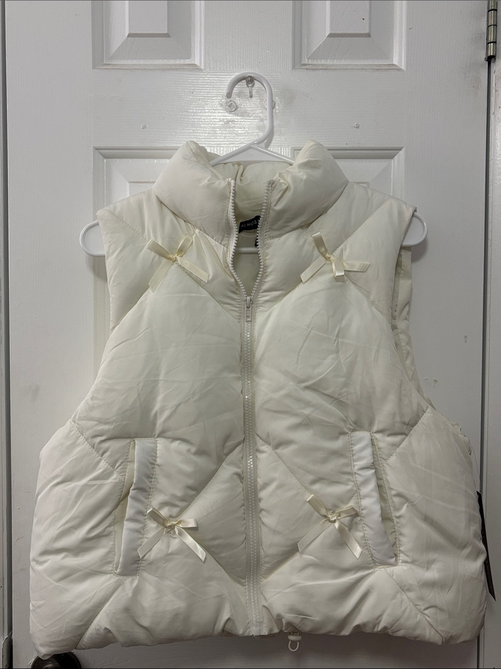 Women's Cream Puffer Vest with Bow Accents